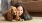 a person lying on the floor with a dog