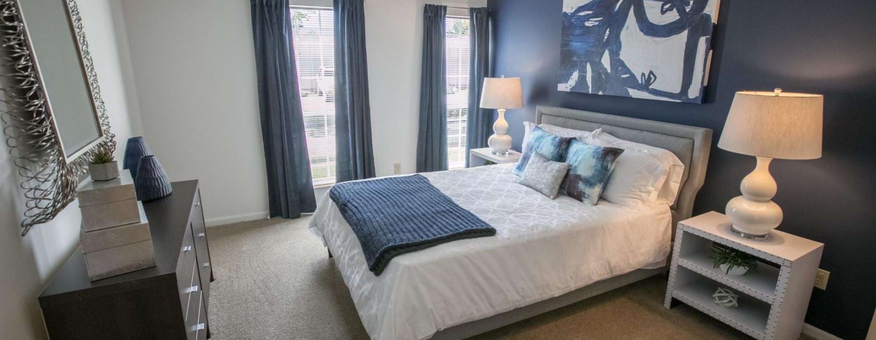 a bedroom with a bed and lamps