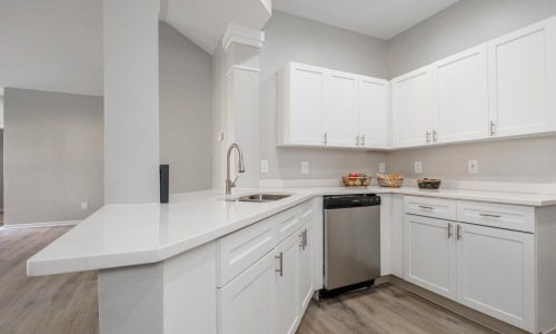 a kitchen with white cabinets