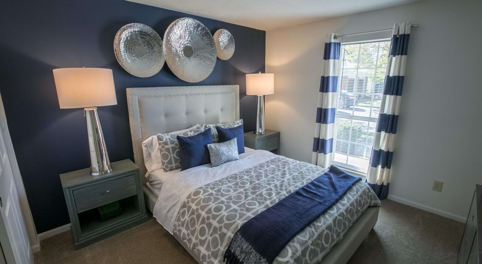 Relax and recharge in beautiful and spacious bedrooms a bedroom with a bed and lamps