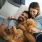 a couple of women lying in bed with stuffed animals
