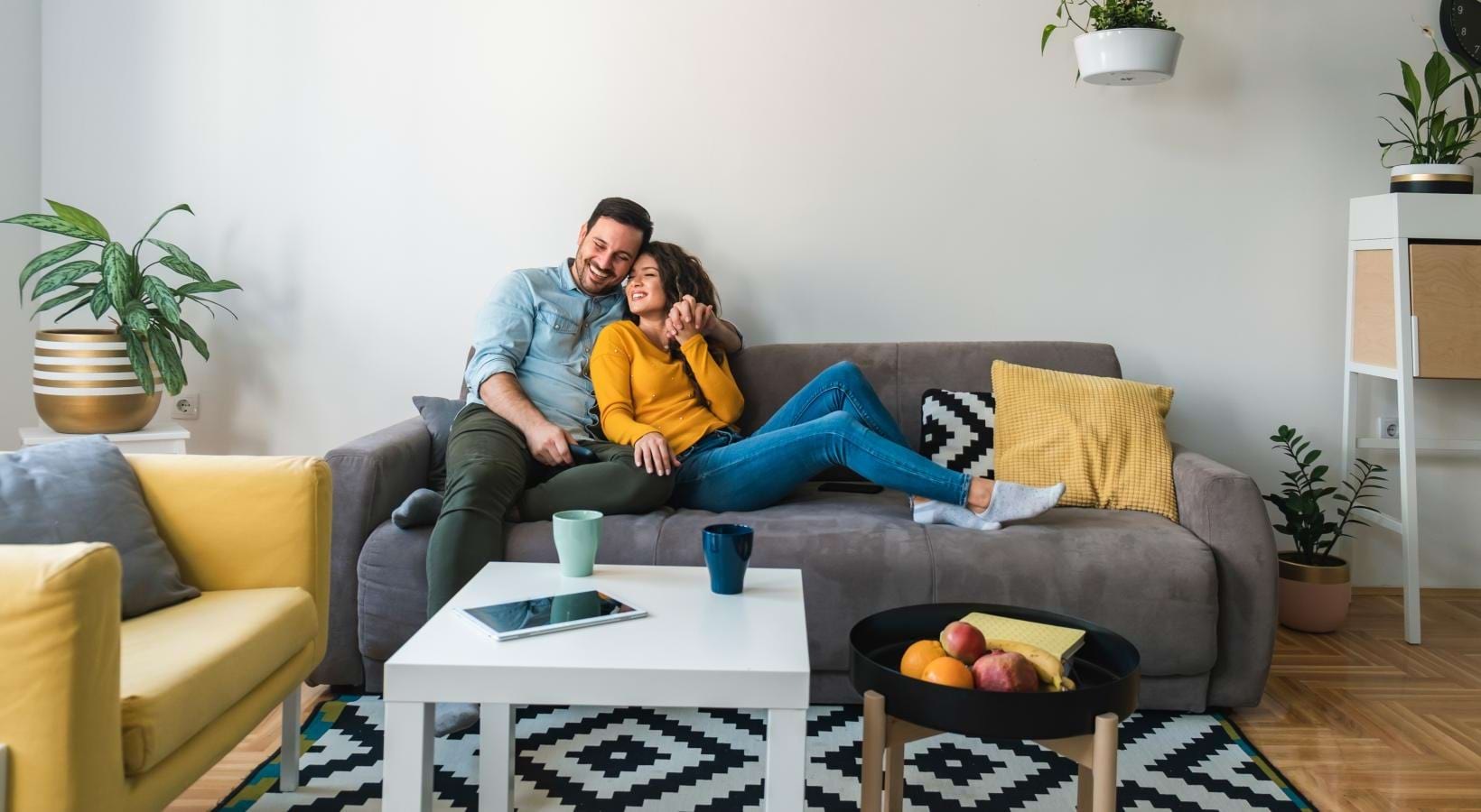 Generous living spaces to relax and unwind a man and woman sitting on a couch