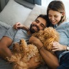 couple laying in bed with family dog