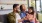 a family sitting on a couch